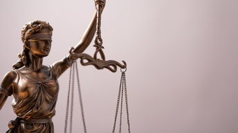 Figur Justitia, die die Waage der Gerechtigkeit in der Hand hält