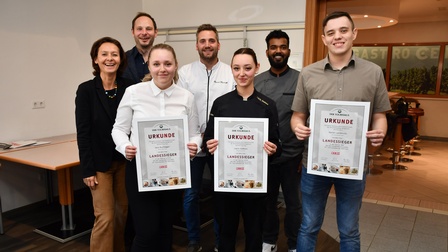 Die Landessieger Sara Buchegger (Service), Leyla Szakacs (Küche) und Daniel Laczkovits (HGA) (vorne, v. l.) mit der Jury Sylvia Unter (HGA), Simon Tury (Service) und Bernd Konrath (Küche) sowie Betreuer Sonu Anil Kumar Renukumari (hinten, v. l.).