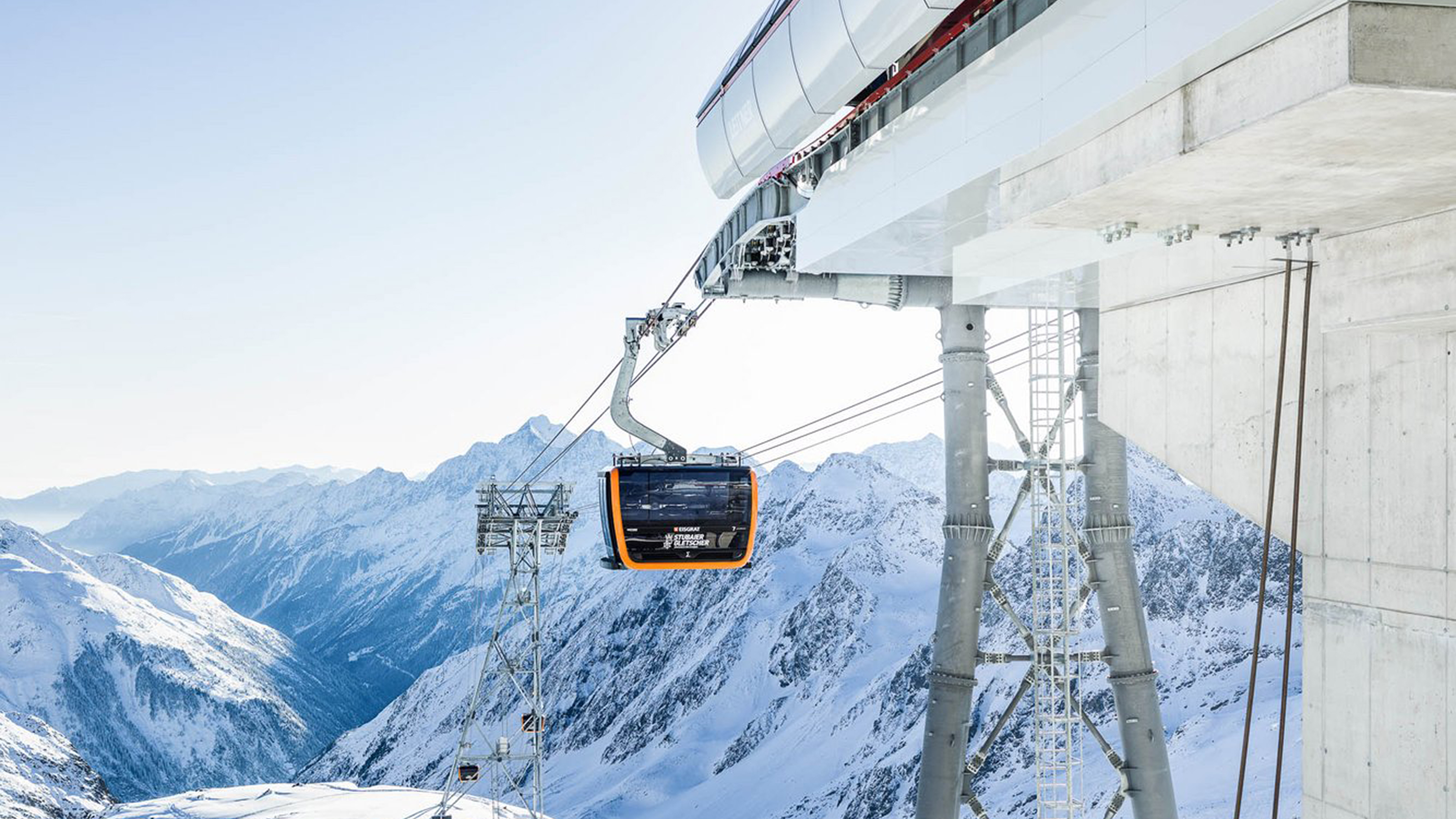 Seilbahn und beschneite Berge